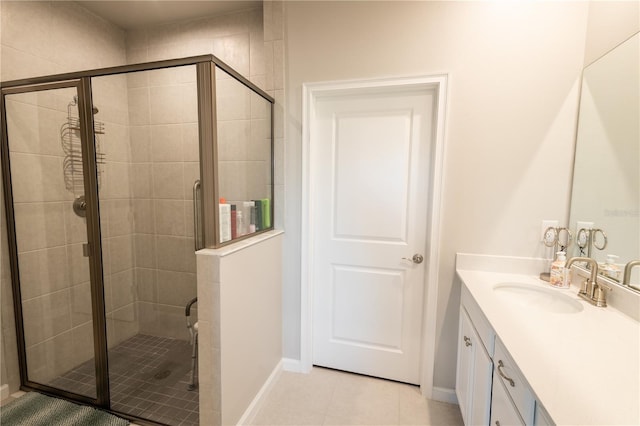 bathroom with tile patterned floors, vanity, and walk in shower