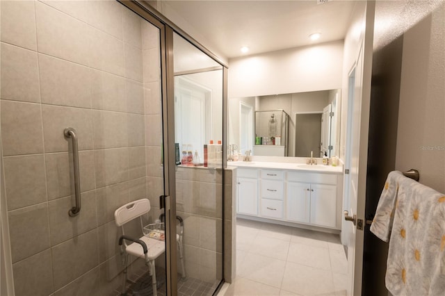 bathroom with tile patterned flooring, vanity, and an enclosed shower