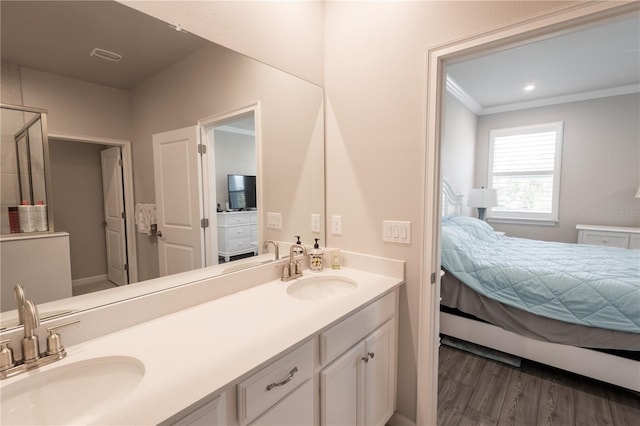 bathroom featuring hardwood / wood-style floors, vanity, and crown molding