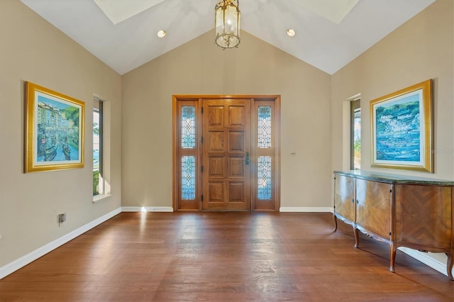 foyer entrance with recessed lighting, high vaulted ceiling, baseboards, and wood finished floors