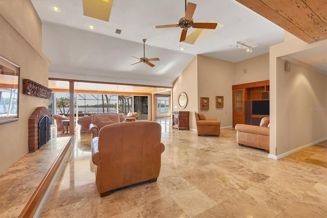 living area featuring visible vents, high vaulted ceiling, track lighting, baseboards, and ceiling fan