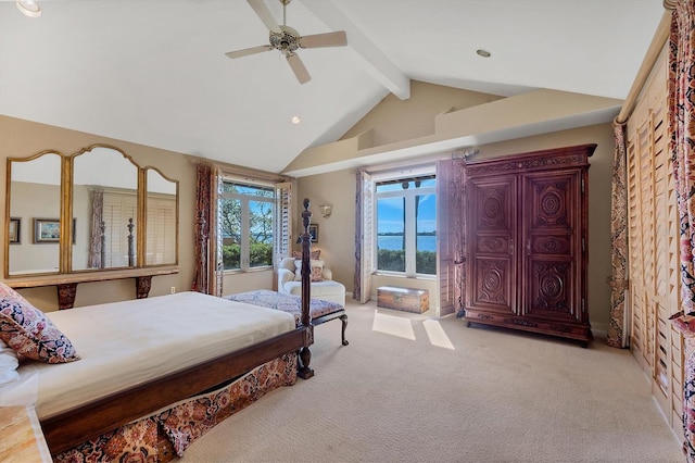 bedroom with a ceiling fan, carpet, and vaulted ceiling with beams