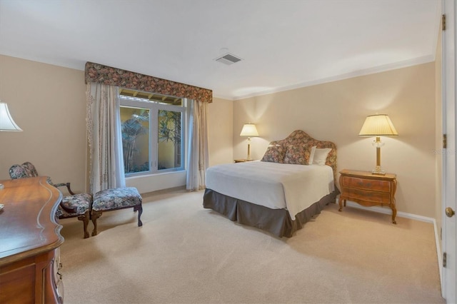 carpeted bedroom with visible vents, baseboards, and ornamental molding