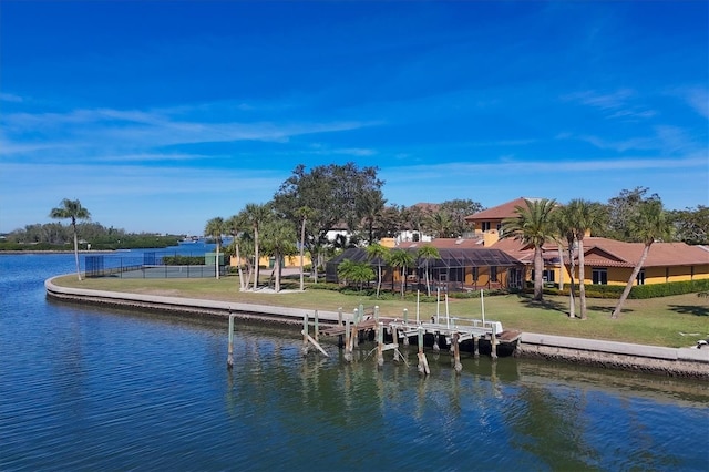 dock area with a lawn and a water view