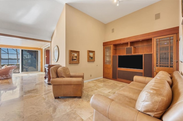 living room with a high ceiling, visible vents, baseboards, and marble finish floor