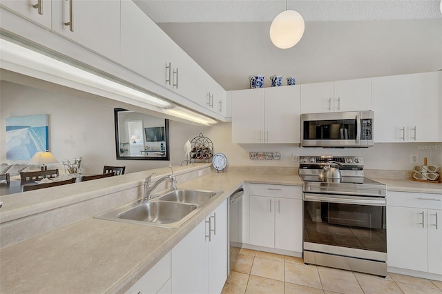 kitchen featuring white cabinetry, sink, hanging light fixtures, stainless steel appliances, and light tile patterned floors