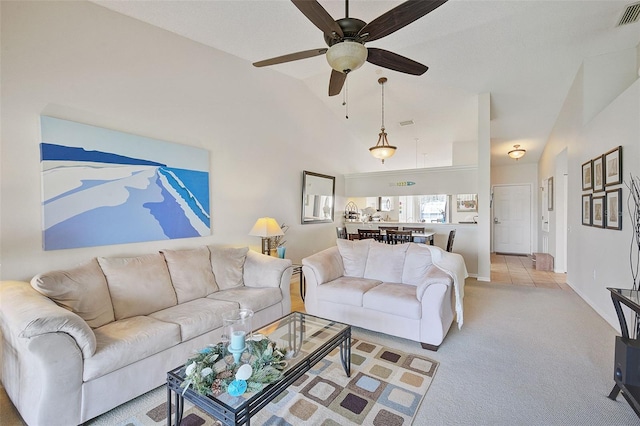 living room with ceiling fan, light colored carpet, and vaulted ceiling