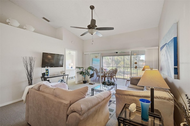 carpeted living room with ceiling fan and high vaulted ceiling