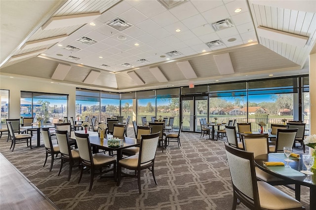 carpeted dining room featuring expansive windows