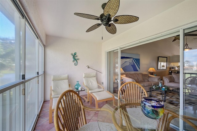 sunroom featuring ceiling fan, plenty of natural light, and vaulted ceiling