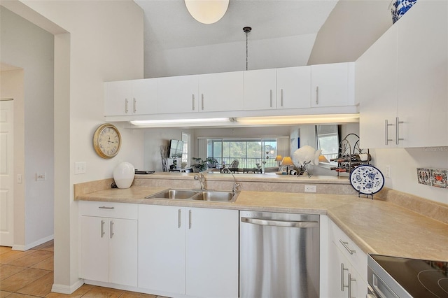 kitchen featuring sink, white cabinets, stainless steel appliances, and decorative light fixtures