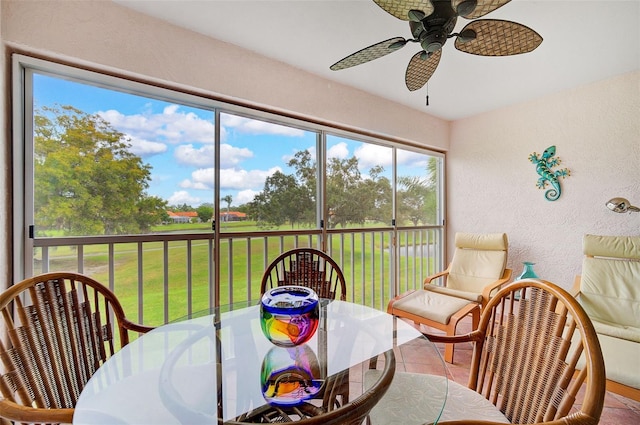 sunroom featuring ceiling fan and a healthy amount of sunlight