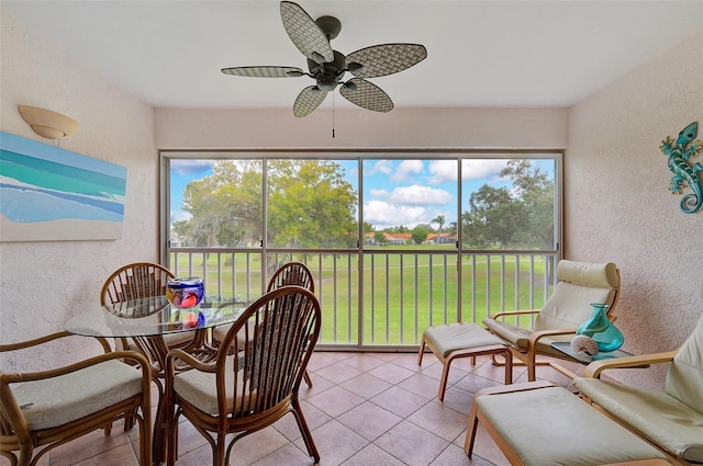 sunroom featuring ceiling fan