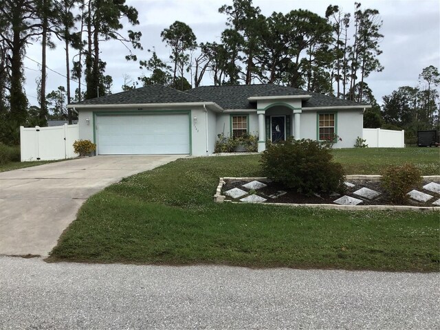 ranch-style home with a garage and a front yard