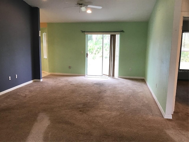 empty room with ceiling fan and light colored carpet