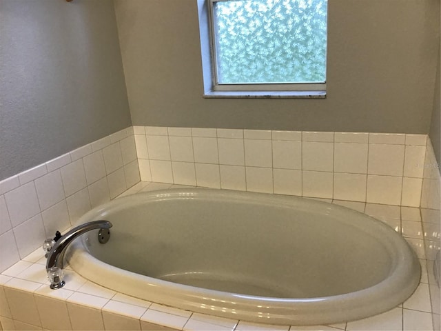 bathroom featuring tiled tub