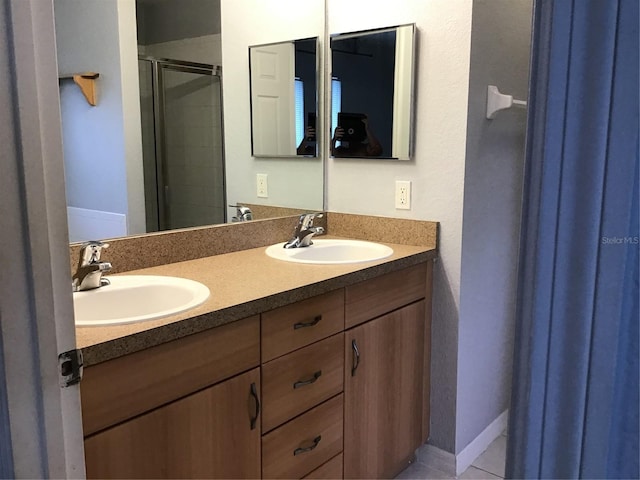 bathroom featuring vanity and an enclosed shower