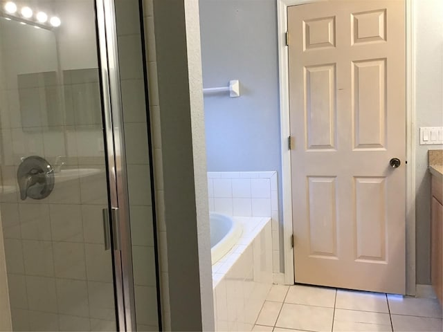 bathroom featuring vanity, shower with separate bathtub, and tile patterned flooring