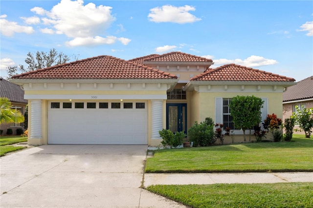 mediterranean / spanish-style home with a garage and a front lawn