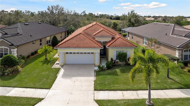 mediterranean / spanish house featuring a garage and a front yard