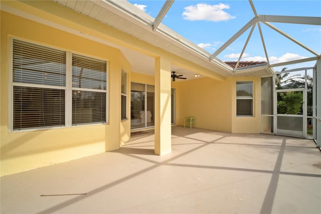 view of patio featuring a lanai and ceiling fan