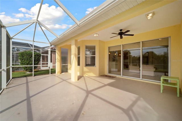 unfurnished sunroom with ceiling fan