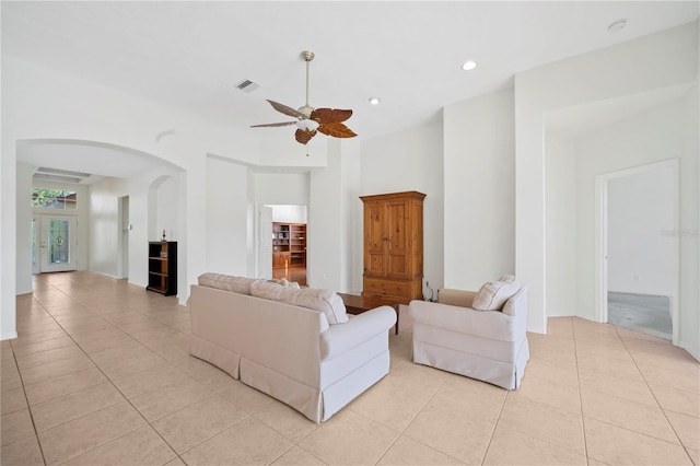 living room with ceiling fan and light tile patterned flooring