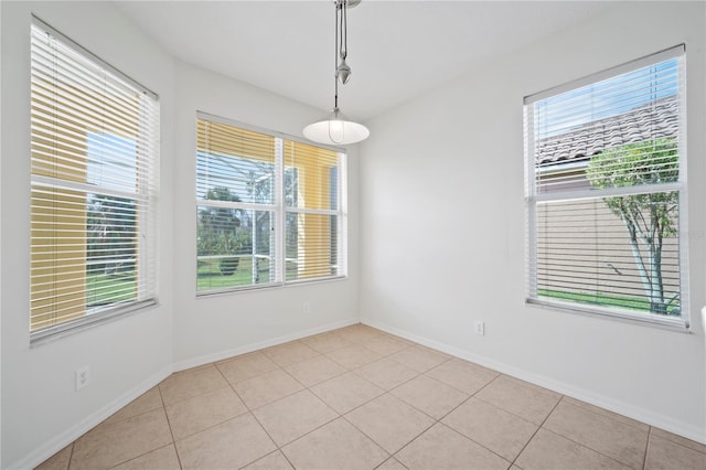 tiled spare room featuring a wealth of natural light