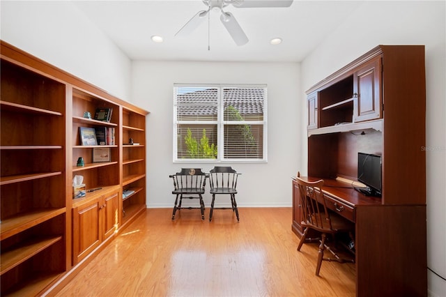 home office featuring light hardwood / wood-style flooring and ceiling fan