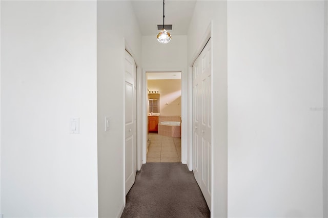 corridor featuring dark tile patterned floors