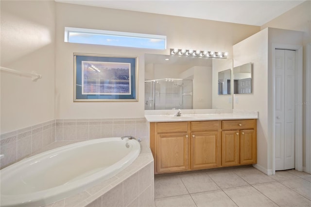 bathroom featuring plus walk in shower, vanity, and tile patterned floors