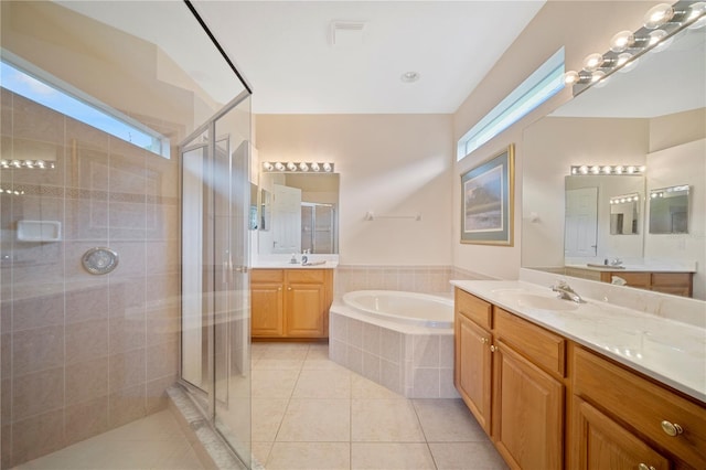 bathroom featuring tile patterned floors, vanity, and shower with separate bathtub