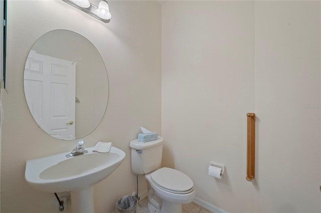 bathroom featuring tile patterned floors, toilet, and sink