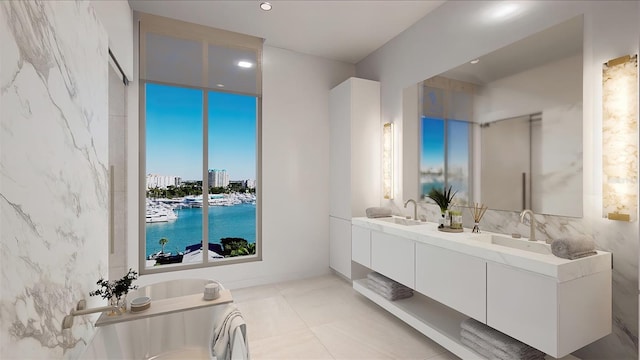 bathroom with tile patterned flooring, vanity, a water view, and tile walls