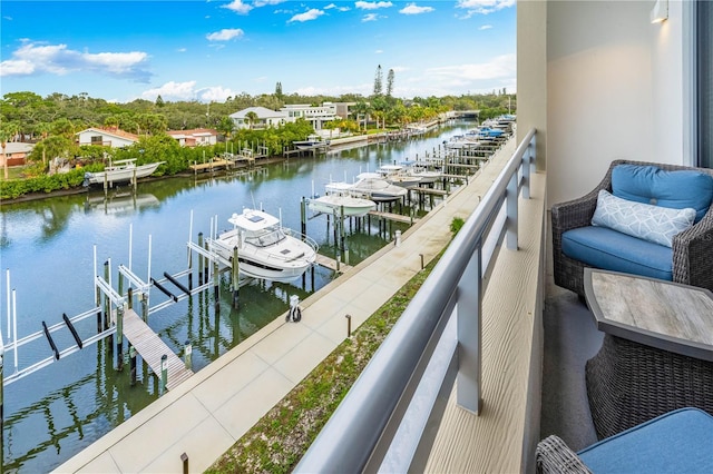 balcony featuring a water view and a boat dock