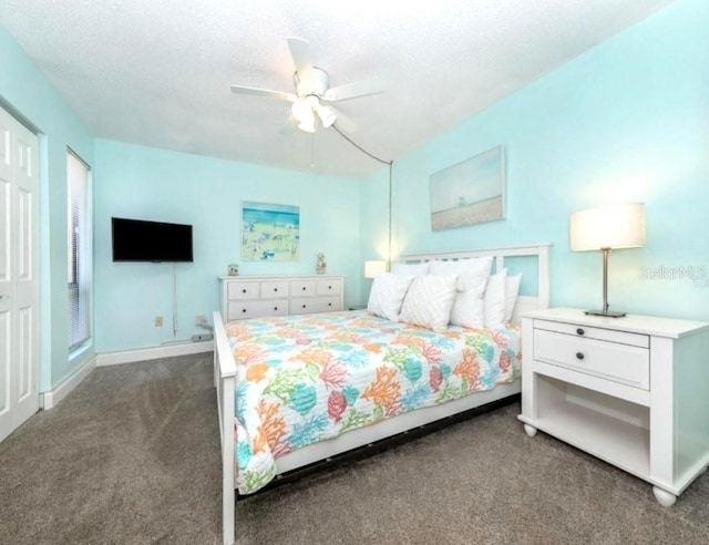 carpeted bedroom featuring ceiling fan and baseboards