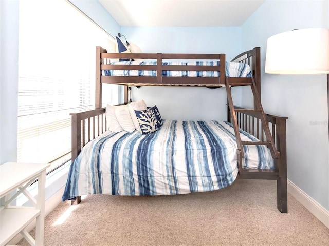 carpeted bedroom featuring baseboards