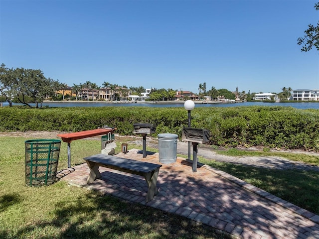 view of property's community featuring a water view and a patio area
