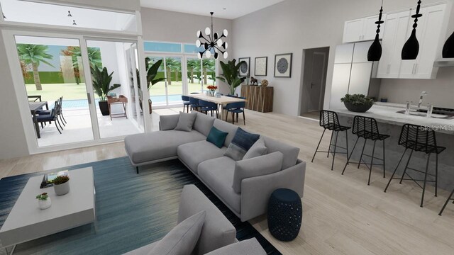 living room with an inviting chandelier, sink, and light hardwood / wood-style flooring