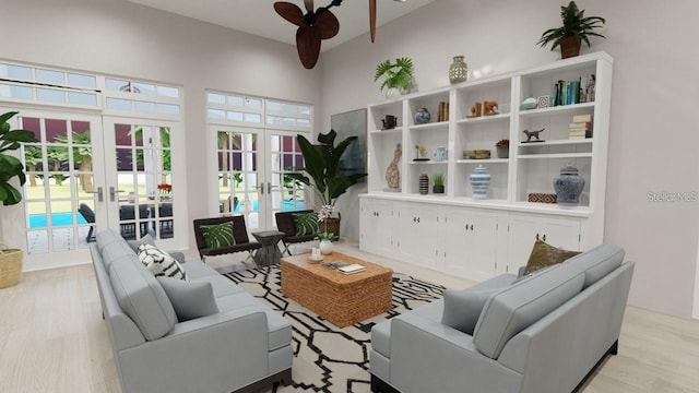 living room featuring a towering ceiling, light hardwood / wood-style flooring, french doors, and ceiling fan