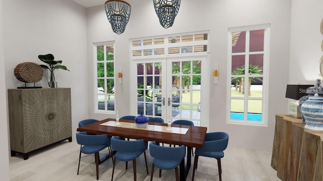 dining space featuring french doors and light wood-type flooring