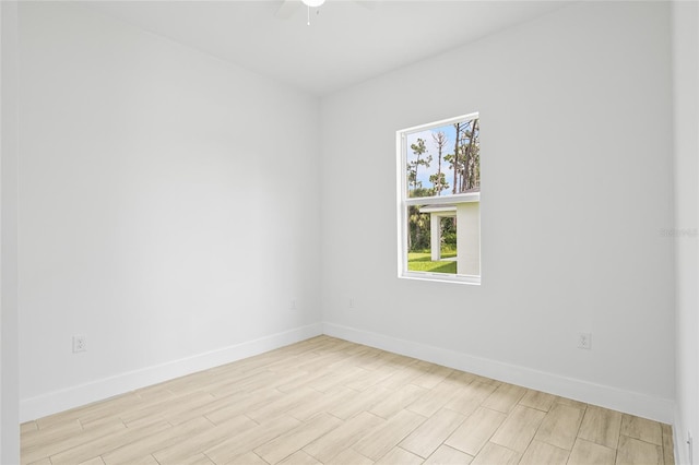 empty room with light wood-type flooring and ceiling fan