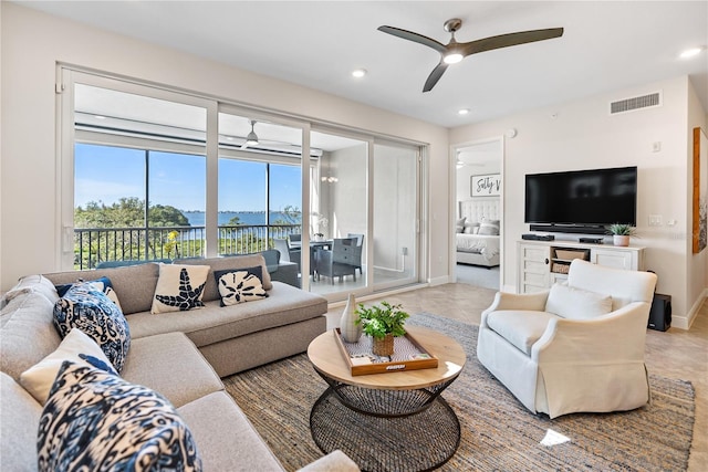 living room with ceiling fan and light tile patterned floors