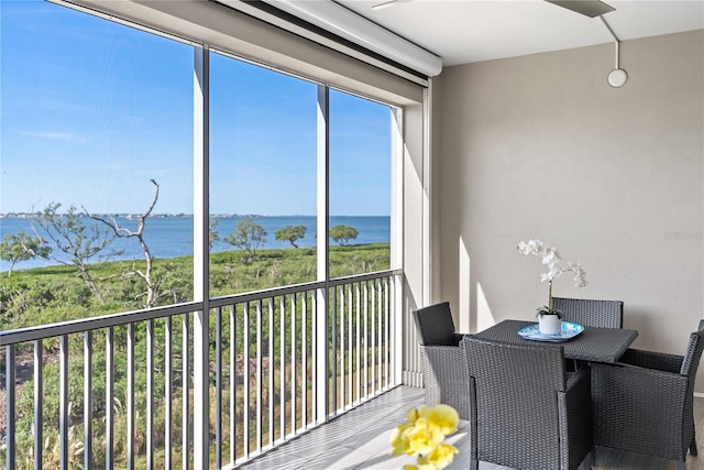 sunroom / solarium with a water view