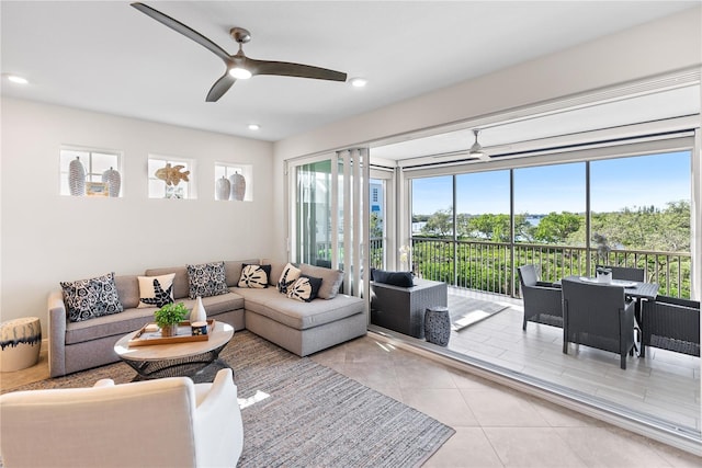 tiled living room featuring ceiling fan and a wealth of natural light