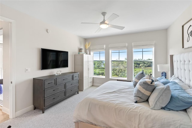 bedroom featuring light carpet and ceiling fan