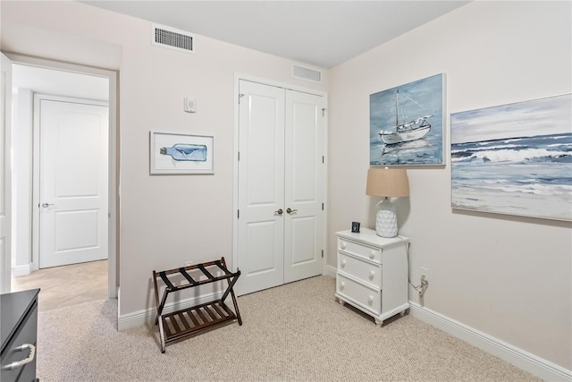 living area featuring light carpet