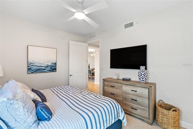 bedroom featuring light colored carpet and ceiling fan