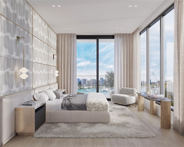 bedroom featuring a water view, expansive windows, access to exterior, and light wood-type flooring