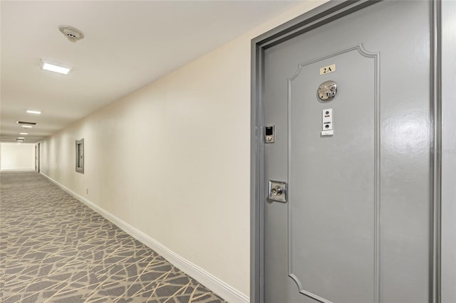 corridor with carpet flooring and baseboards